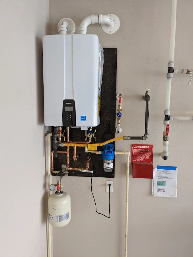 Professional plumber installing copper piping in a Union Springs home